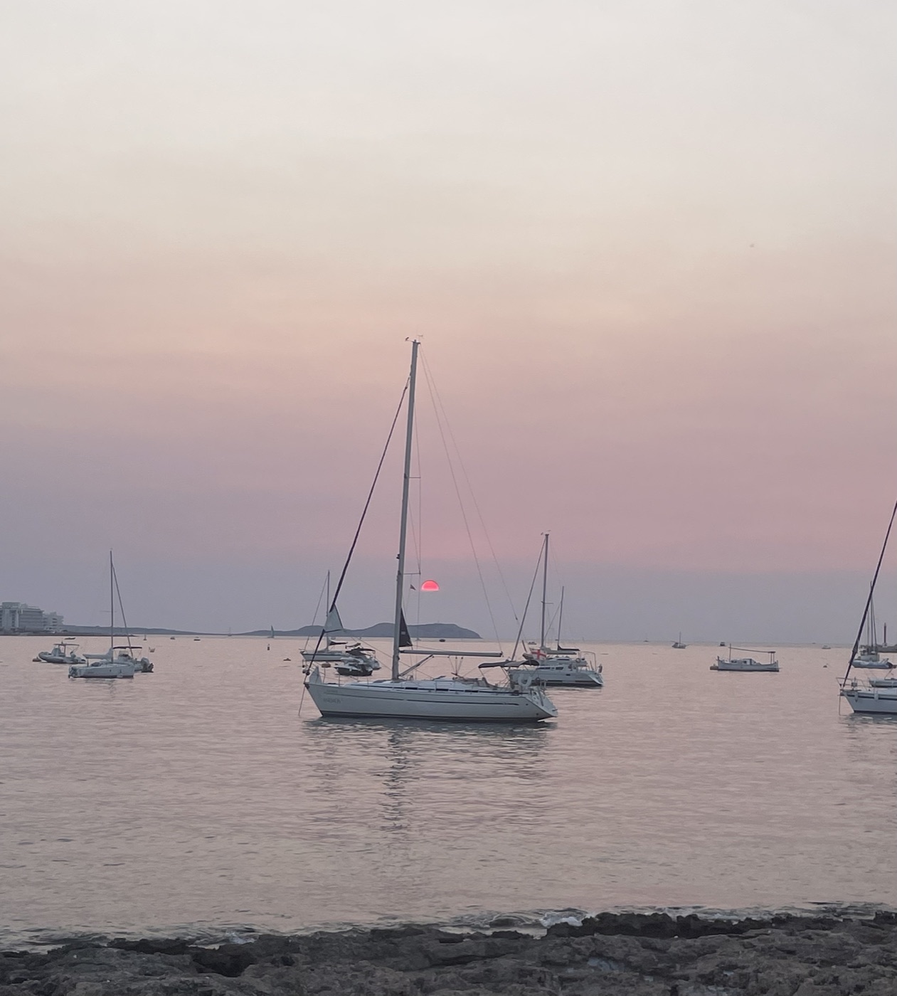 Sailing boats at anchor at sunset